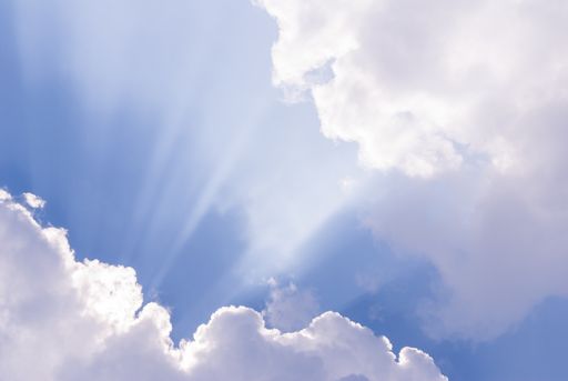 A beautiful blue sky with sunlight coming through clouds