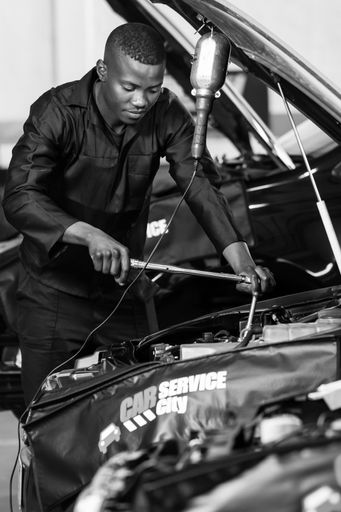 Johannesburg, South Africa - July 14, 2017: Mechanics in Car Service City Workshop repairing and diagnosing motor vehicles 