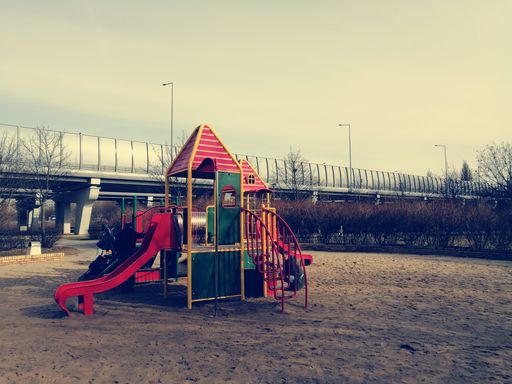 Kids playing with equipment at a playground in the Rataje park.