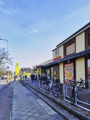 Berlin, Germany - February 20, 2021: Looking down a street in Berlin, Germany, with a supermarket on the right side.