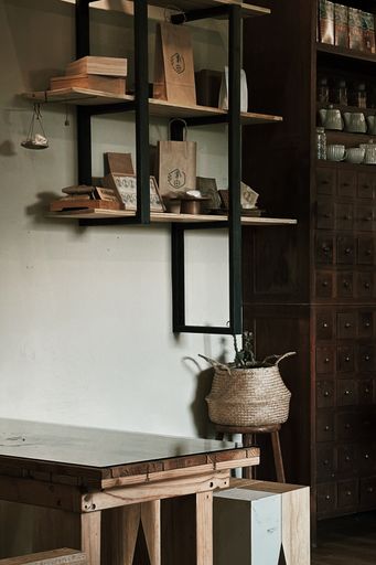 A vertical shot of a wooden table under a wall cabinet