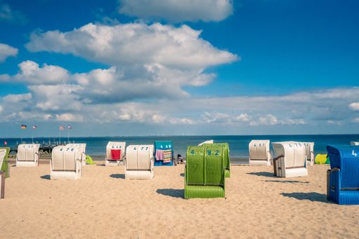 A scenic view of a beach with colorful sun chairs in Flora Bama, Perdido Key, Florida USA