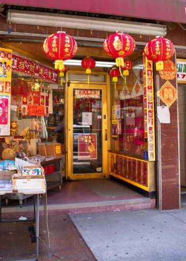The red lanterns in front of yellow Chinese store in Chinatown, New York