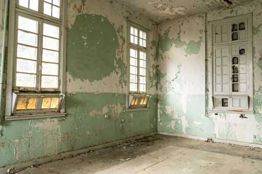 An abandoned hospital building with peeling walls in Amiantos, Cyprus