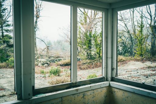 A closeup shot of broken windows of the Amiantos Abandoned Hospital in Cyprus