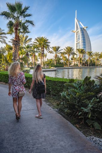 Back view of a two young blonde female enjoying the view of Burj al Arab in Dubai