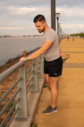 A vertical shot of a young athletic male stretching on the bridge