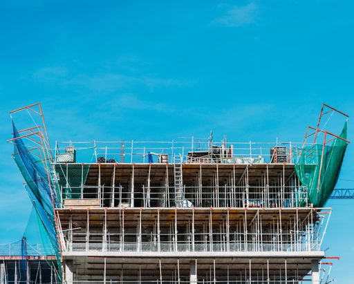 A scenic view of a building under construction against a clear blue sky background