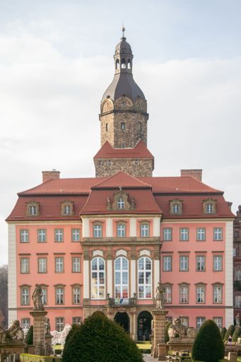 An aged brick Ksenzh castle against a blue clear sky
