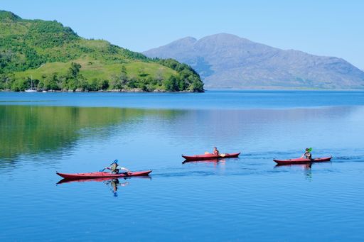 A beautiful shot of people on kayaking boats in the sea