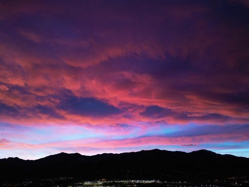 A stunning view of a cityscape at dusk, with the sky above a blend of pink hues