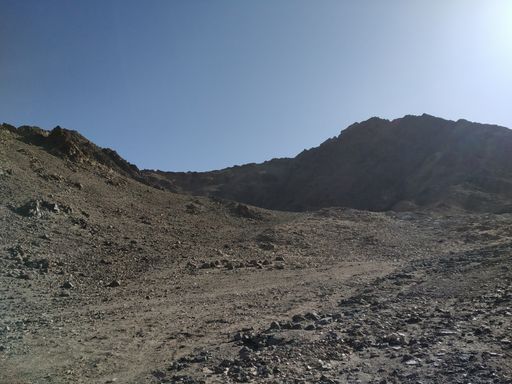 A scenic view of a rocky mountain under a clear sky background
