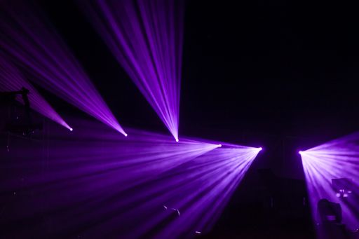 A purple laser party lights against black backgro on the studio