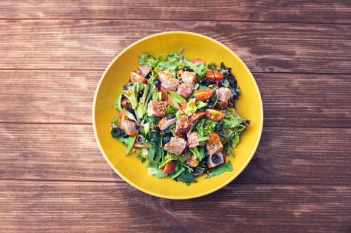 A top view of vegetable salad on wooden table