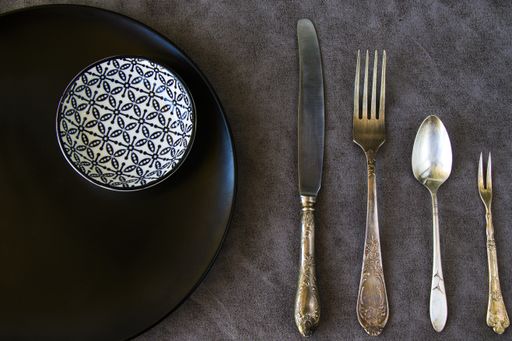 A flat lay of table settings on grey background