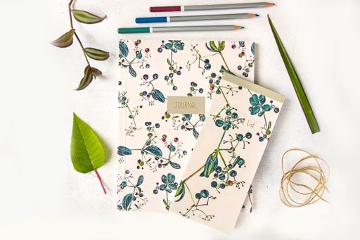 A notebook, pencils, and plants on the white background