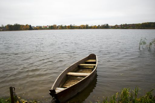 The old wooden boats near the beach of Trakai Gavle lake, Lithuania. Autumn and fall time.