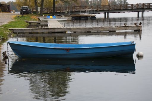 The old wooden boats near the beach of Trakai Gavle lake, Lithuania. Autumn and fall time.