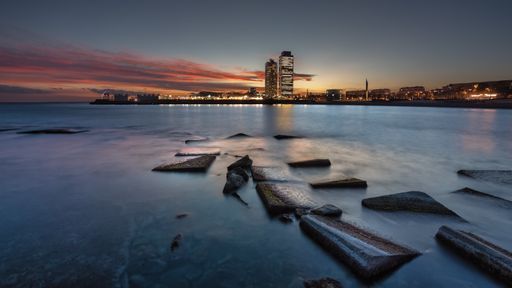 Beautiful sunset in Barcelona beach, in front of the city with views of Ars Hotel