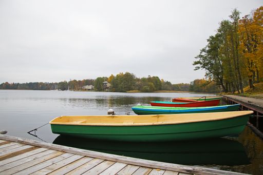 A beautiful autumn scene of old wooden boats moored near the beach of Gavle lake in Trakai, Lithuania