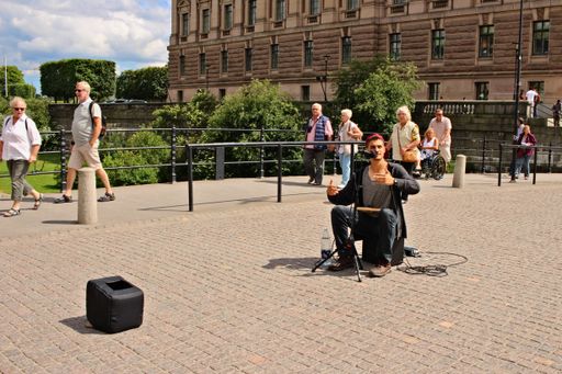 A street musician busking for money on the streets of Stockholm, Sweden.