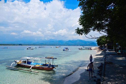 Traditional Indonesian boats anchored next to the popular party island of Gili Trawangan near Bali.
