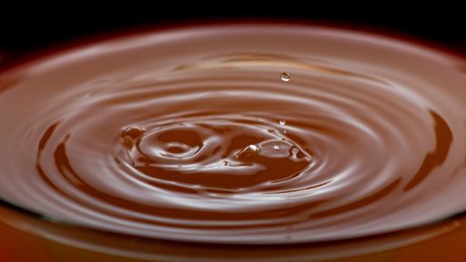 A water drop ripple on a caramel background