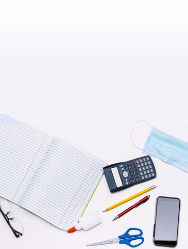 School supplies for school, notebooks, pens, scissors and a mask. education, pandemic and the new normal concept.