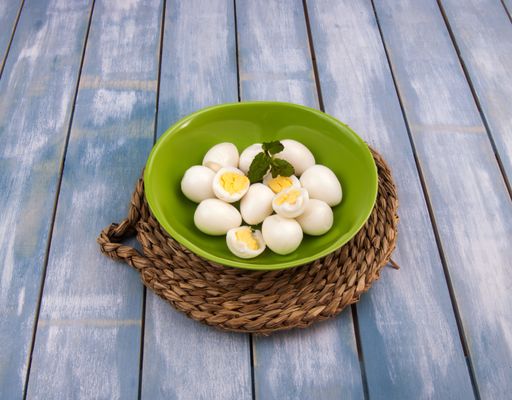 A high angle shot of a bowl of boiled quail eggs on the table