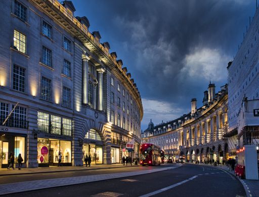 A scenery of people walking in the historic city of London during evening time