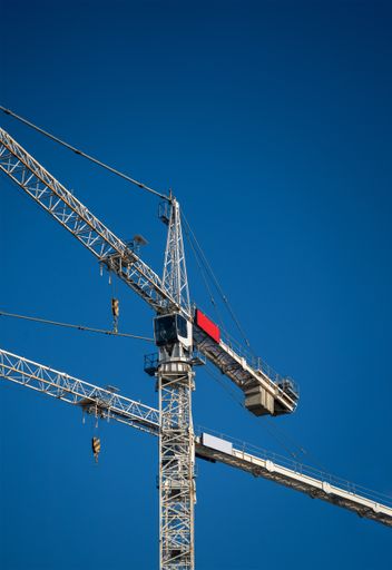A low angle shot of a large metal tower under a clear blue sky