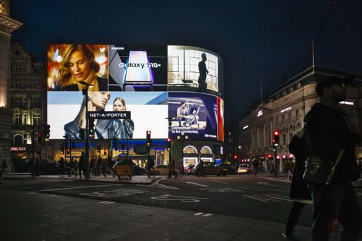A scenery of people walking in the historic city of London during evening time