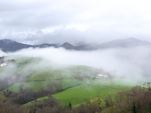 Mountains with fog and low clouds, pastures of Spanish Basque Country.