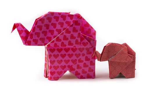 A closeup shot of patterned origami elephants of different sizes isolated on a white background