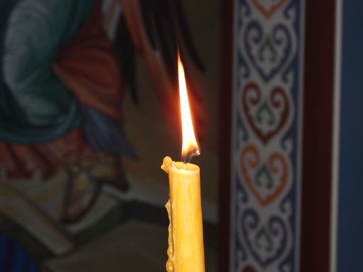 A closeup of a lit yellow candle