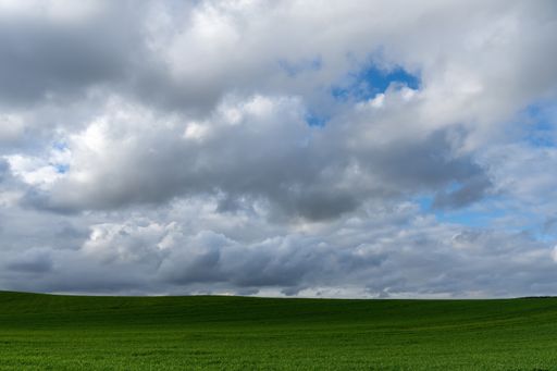 Stock photo of rural landscape against blue sky.
