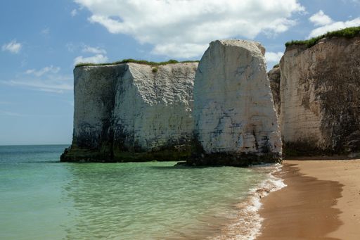 The White Cliffs of Dover surrounded by the sea and the beach under the sunlight in the UK
