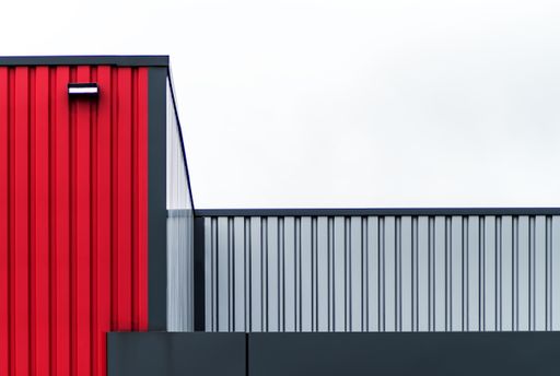 A closeup shot of a modern gray and red building