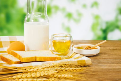 A closeup of rustic natural products on a wooden surface and blurred plants background