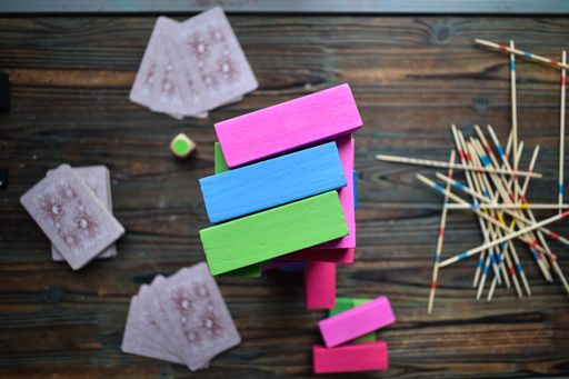 A top view of colorful wooden blocks, wood stocks, and cards on table