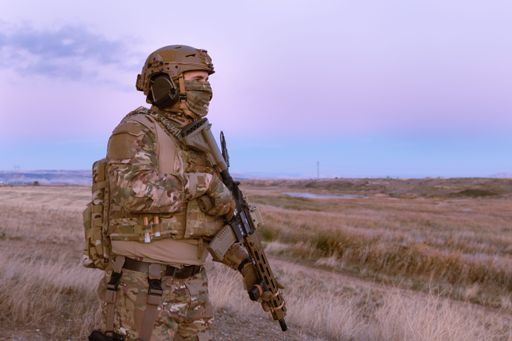 A man wearing a military uniform with a rifle