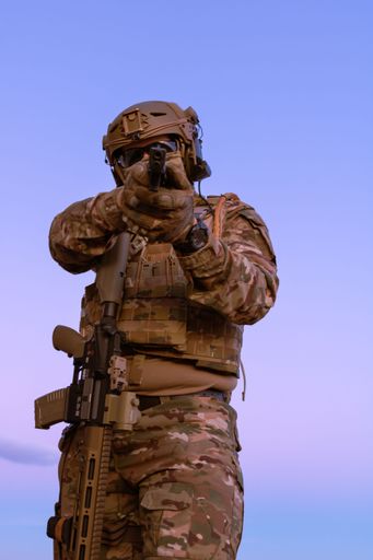 A man wearing a military uniform with a rifle
