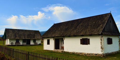 A beautiful view of village old houses with fence against a clear blue sky