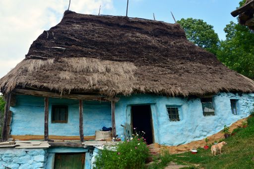 A closeup shot of an old Romanian traditional straw-roofed house