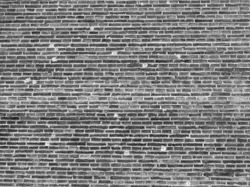 A grayscale shot of a brick wall - perfect for the backdrop