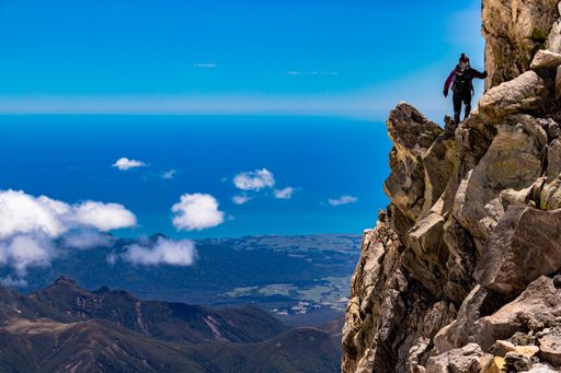 A person climbing the Taranaki summit, New Zealand during daylight
