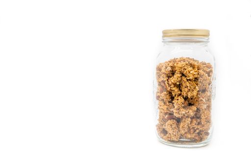 A jar filled with granola isolated on a white background