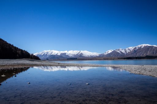 Lake Tekapo with blue sky and reflecting scenery of the mountains, New Zealand