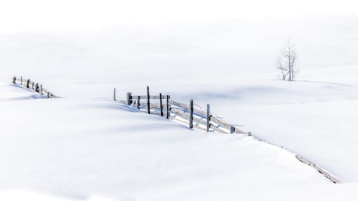Minimalism in winter. Fence in deep snow
