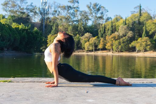 A closeup shot of a young woman practicing yoga in a park on a sunny day